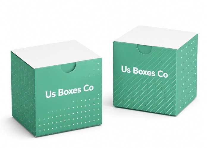 Two green US Boxes Co cube boxes with white lids.