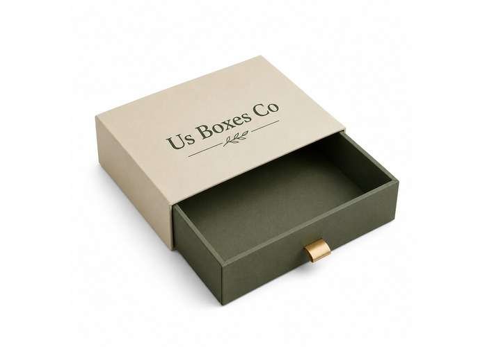 Cream and olive green drawer-style rigid gift box with a gold pull tab, shown partially open on a white background.