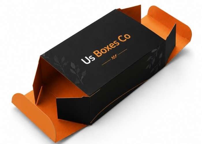 Black tuck-end box with orange interior and custom logo.