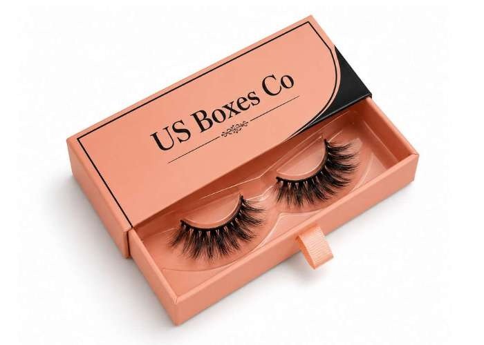 Peach eyelash box with “US Boxes Co” branding and dramatic false lashes.