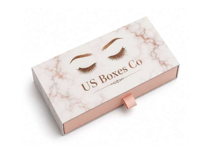 Marble-patterned eyelash box with “US Boxes Co” branding and a pink pull tab.